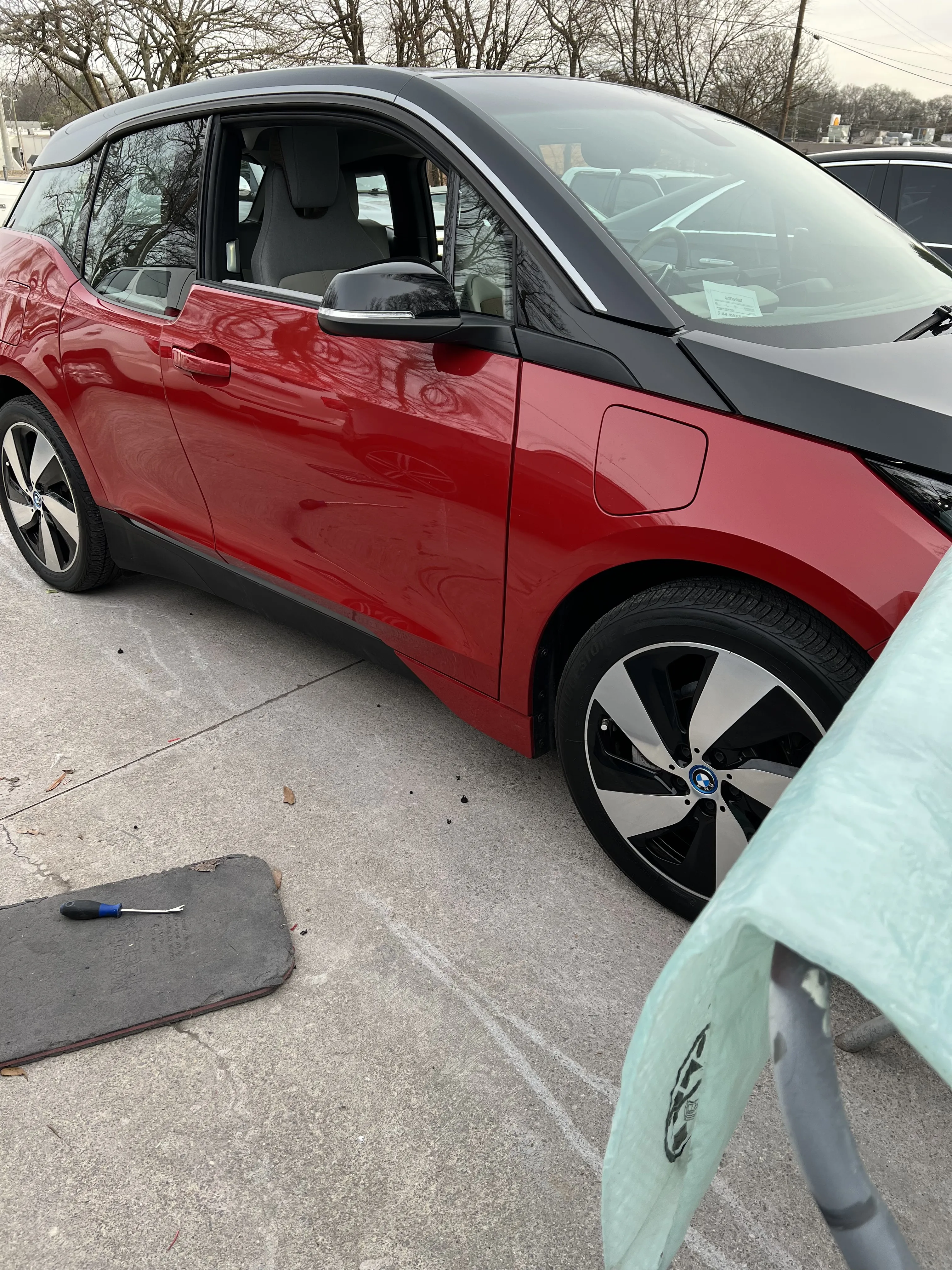 Auto body repair specialist assisting military personnel with body repair services, focusing on the important goal of restoring the vehicle to top condition.